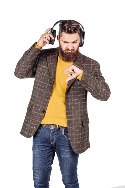 Bearded man listens to music through headphones over isolated wh — Stock Photo, Image