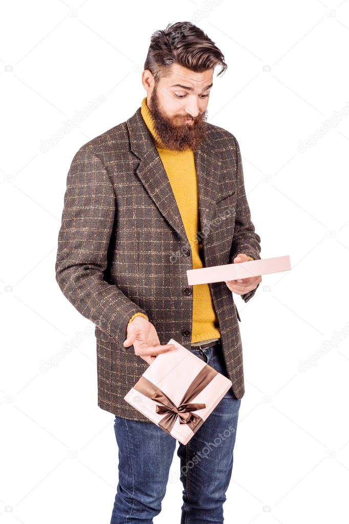 portrait unhappy, upset man holding gift box 