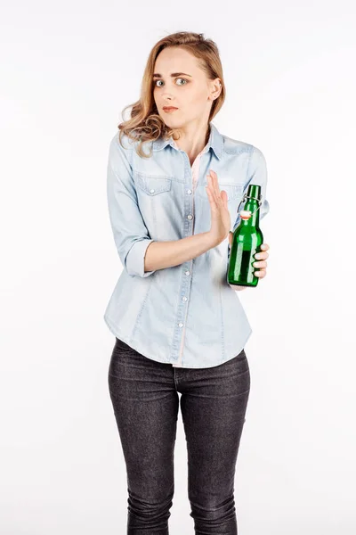 Female hand rejecting bottle with alcoholic beverage — Stock Photo, Image