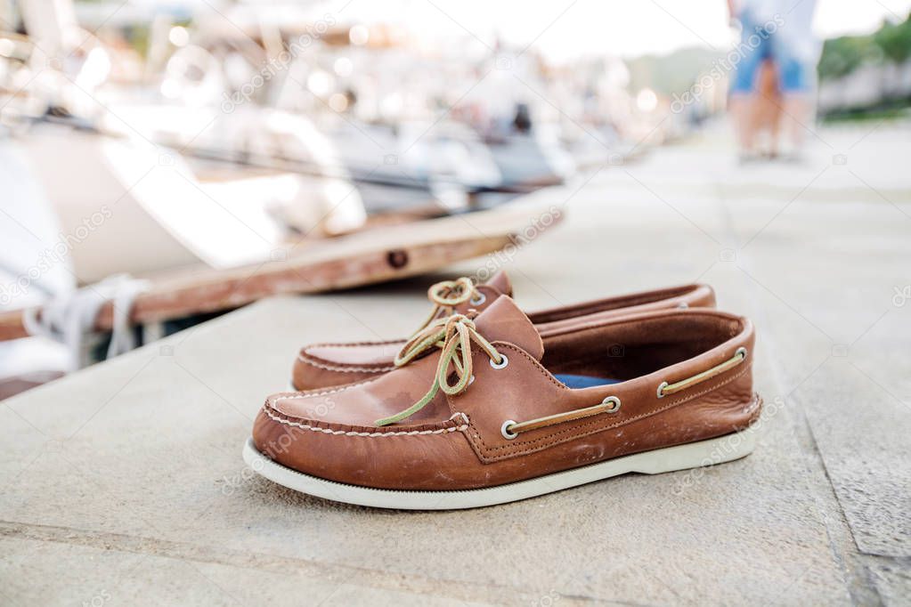 Mens brown loafers shoe on a pier