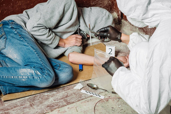 Criminological expert collecting evidence at the crime scene. Law and police concept