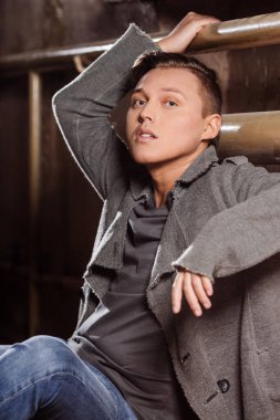 Duvara yakın oturan adam. Şık bir tarzda bir adam.