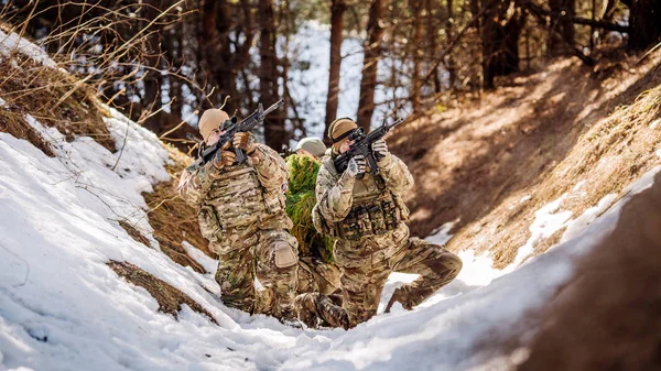 Group of special forces weapons in cold forest. Winter warfare and military concept