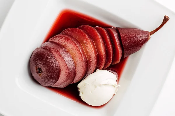 Dessert sliced poached pears in red wine served in white plate w — Stock Photo, Image