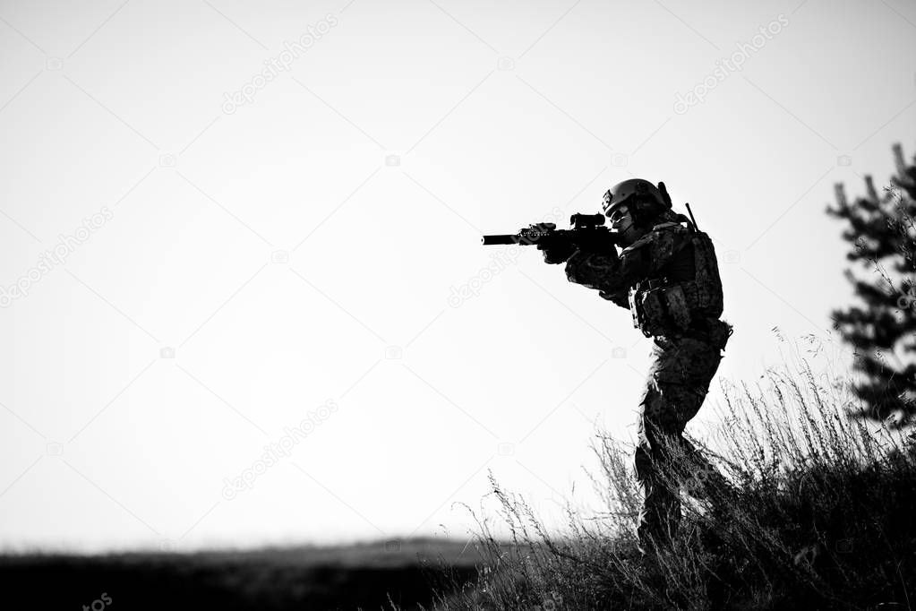 military soldier with weapons at sunset. shot, holding gun, colo