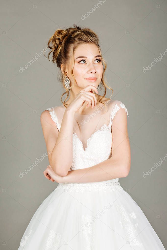 thinking bridal looking away on grey background. people and emotion concept