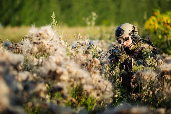 Retrato de soldado joven con rifle contra un fondo atardecer — Foto de Stock