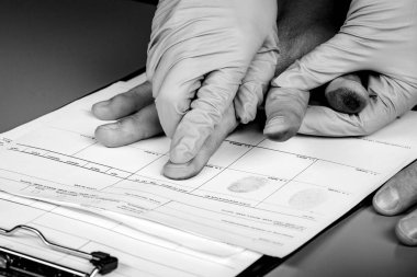 police takes fingerprints of a criminal clipart