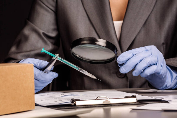 Detective through a magnifying glass looking at a evidence