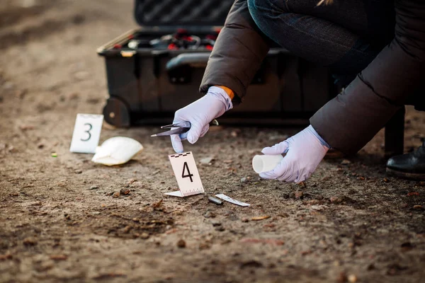 Crime scene investigation - collecting bullet  sleeve of pisto — Stock Photo, Image