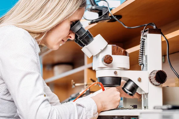 woman repairing computer hardware in service center. Repairing a