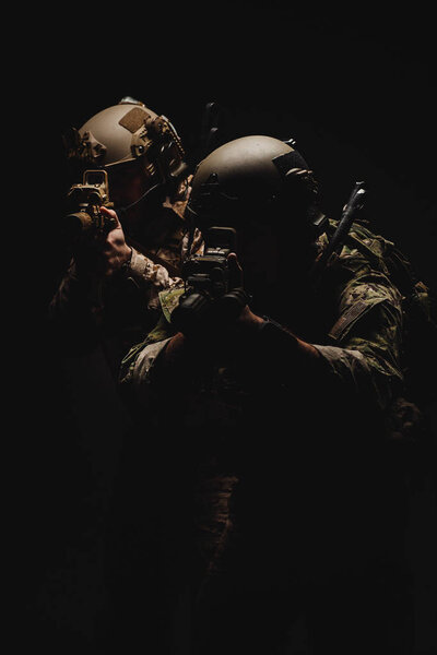 Special forces United States soldiers or private military contractors holding rifle. Image on a black background. war, army, weapon, technology and people concept