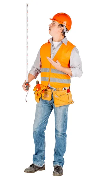 Builder Helmet Holding Tape Measure His Hands White Wall Background — Stock Photo, Image