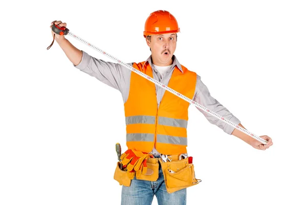 Builder Helmet Holding Tape Measure His Hands White Wall Background — Stock Photo, Image