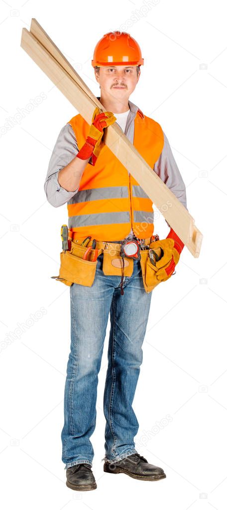 builder in a helmet holding wood boards and looking at camera over white wall background. repair, construction, building, people and maintenance concept.