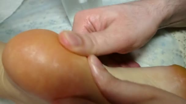Therapeutic massage with his feet with his hands — Stock Video