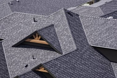 Rooftop in a newly constructed subdivision in Kelowna British Columbia Canada showing asphalt shingles clipart