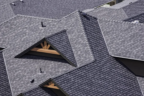 Rooftop in a newly constructed subdivision in Kelowna British Columbia Canada showing asphalt shingles — Stock Photo, Image