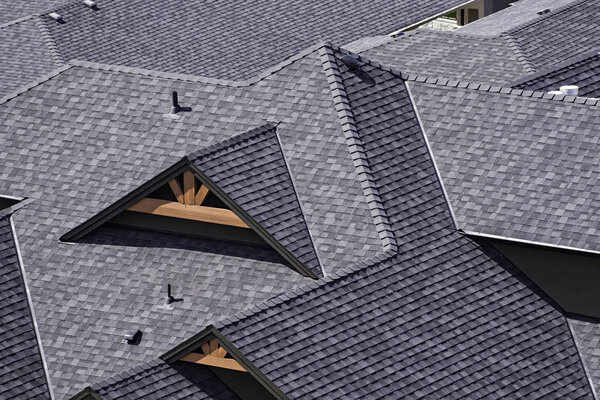 Rooftop in a newly constructed subdivision in Kelowna British Columbia Canada showing asphalt shingles