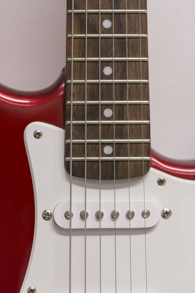 Red Electric Guitar Close Up with white background.