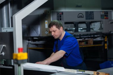 Kişinev, Moldova - 26 Nisan 2016: İşçilerin basımevi. Yazdırma fabrikasında baskı makinesinde çalışan insanlar. Kişinev, Moldova üzerinde 26 Nisan 2016 yılında sanayi işçileri