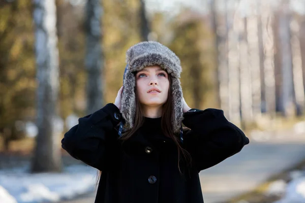 Winter. Girl in cold weather. Beautiful girl in the winter outdoors. Woman in winter cap.