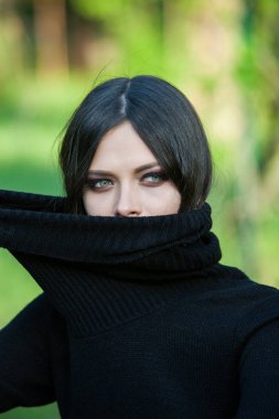 Trendy kazağını üzerinde kafa eğleniyor çekerek kız portresi. Açık hava atmosferik yaşam tarzı fotoğraf genç güzel bayan. Mükemmel cilt yüz.