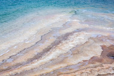 Ürdün 'de gün batımında Ölü Deniz kıyısı manzarası. Gün batımında tuz kristalleri. Mineral yapıları olan ölü deniz manzarası.