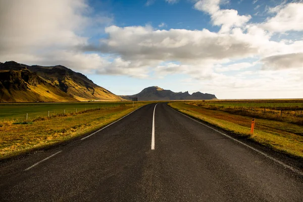 Road through Iceland landscape. Road and car travel scenic and sunset. Road travel concept. Car travel adventure. Travel concept. Freedom.