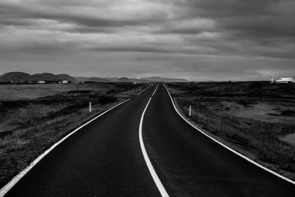 Road through Iceland landscape. Road and car travel scenic and sunset. Road travel concept. Car travel adventure. Travel concept. Freedom.