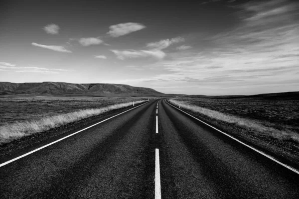 Road through Iceland landscape. Road and car travel scenic and sunset. Road travel concept. Car travel adventure. Travel concept. Freedom.