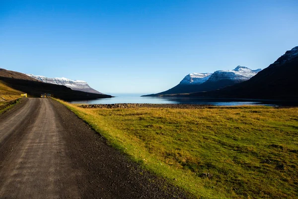 Road through Iceland landscape. Road and car travel scenic and sunset. Road travel concept. Car travel adventure. Travel concept. Freedom.