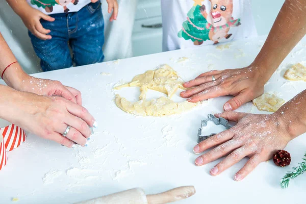 Family cooking homemade cakes. Moms and children hands holding cookie cutters. Family Cooking flat lay. Sweet home. Happiness concept.