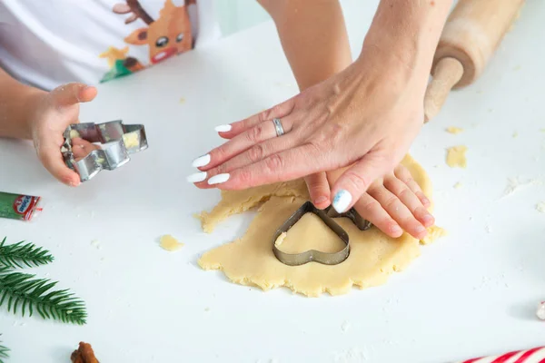 Family cooking homemade cakes. Moms and children hands holding cookie cutters. Family Cooking flat lay. Sweet home. Happiness concept.