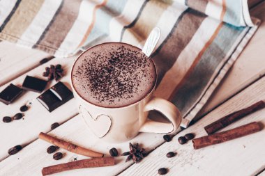 Two cups of hot cocoa with marshmallows and cinnamon sticks on wooden background. Love. Cocoa drink. Valentines day treat ideas.