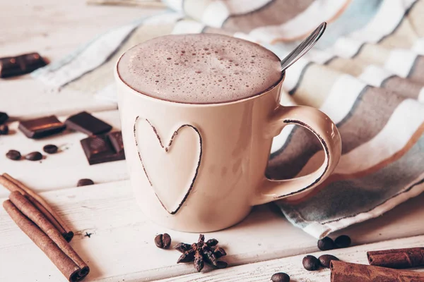 Two cups of hot cocoa with marshmallows and cinnamon sticks on wooden background. Love. Cocoa drink. Valentines day treat ideas.