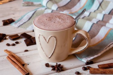 Two cups of hot cocoa with marshmallows and cinnamon sticks on wooden background. Love. Cocoa drink. Valentines day treat ideas.