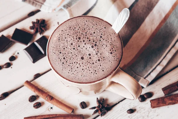 Two cups of hot cocoa with marshmallows and cinnamon sticks on wooden background. Love. Cocoa drink. Valentines day treat ideas.