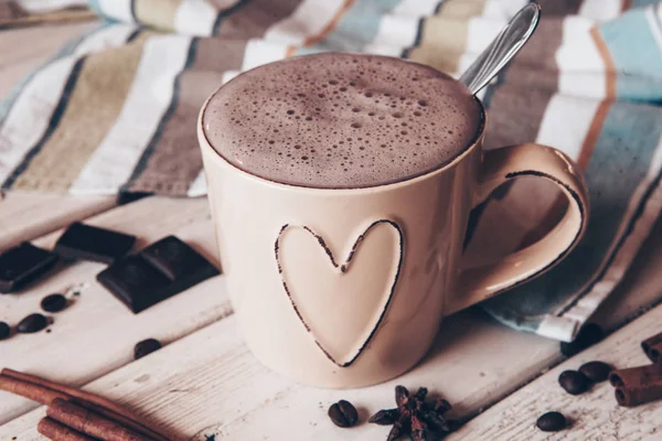 Two cups of hot cocoa with marshmallows and cinnamon sticks on wooden background. Love. Cocoa drink. Valentines day treat ideas.