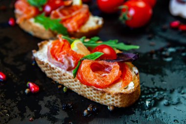 Appetizing bruschetta. Traditional Italian bruschetta. Open sandwich with salmon and vegetables. Delicious healthy food. European cuisine. 
