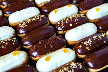 Traditional french eclairs with chocolate. Tasty dessert. Home made cake eclairs Sweet. Dessert. Pastry filled with cream. Chocolate icing.