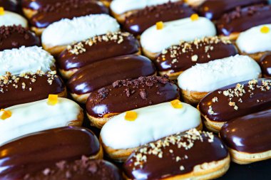 Traditional french eclairs with chocolate. Tasty dessert. Home made cake eclairs Sweet. Dessert. Pastry filled with cream. Chocolate icing.