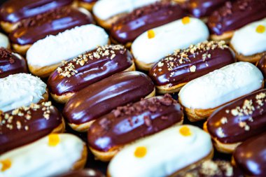 Traditional french eclairs with chocolate. Tasty dessert. Home made cake eclairs Sweet. Dessert. Pastry filled with cream. Chocolate icing.