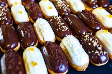 Traditional french eclairs with chocolate. Tasty dessert. Home made cake eclairs Sweet. Dessert. Pastry filled with cream. Chocolate icing.