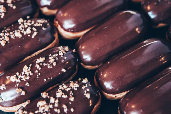 Traditional french eclairs with chocolate. Tasty dessert. Home made cake eclairs Sweet. Dessert. Pastry filled with cream. Chocolate icing.
