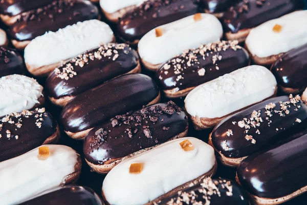 Traditional french eclairs with chocolate. Tasty dessert. Home made cake eclairs Sweet. Dessert. Pastry filled with cream. Chocolate icing.