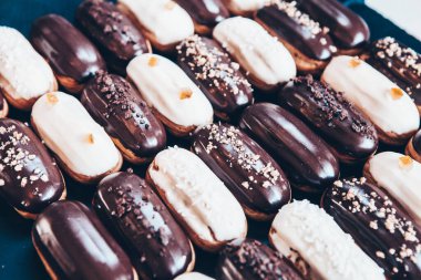 Traditional french eclairs with chocolate. Tasty dessert. Home made cake eclairs Sweet. Dessert. Pastry filled with cream. Chocolate icing.