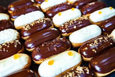Traditional french eclairs with chocolate. Tasty dessert. Home made cake eclairs Sweet. Dessert. Pastry filled with cream. Chocolate icing.