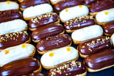 Traditional french eclairs with chocolate. Tasty dessert. Home made cake eclairs Sweet. Dessert. Pastry filled with cream. Chocolate icing.
