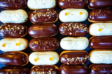 Traditional french eclairs with chocolate. Tasty dessert. Home made cake eclairs Sweet. Dessert. Pastry filled with cream. Chocolate icing.